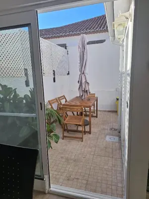 an open door to a patio with a table and chairs at Happy Stay Funchal in Funchal