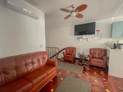 a living room with a couch and two chairs at Villa Supranee Ocean View in Câmara de Lobos