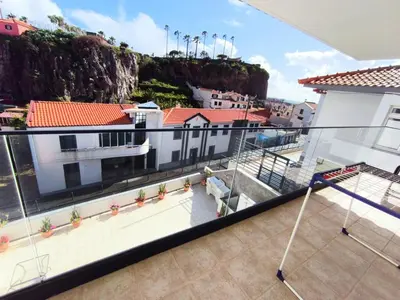 a balcony with a view of a city at Villa Supranee Ocean View in Câmara de Lobos