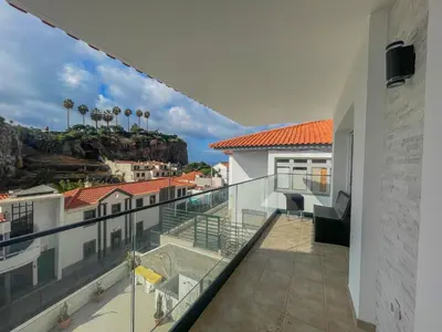 a balcony with a view of a mountain at Villa Supranee Ocean View in Câmara de Lobos