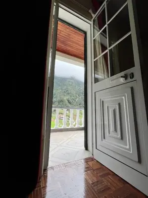 an open door with a view of a balcony at Mountain retreat in Boaventura