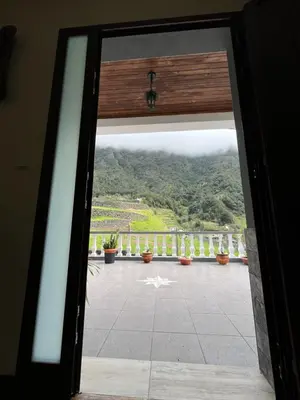 a door to a balcony with a view of a mountain at Mountain retreat in Boaventura