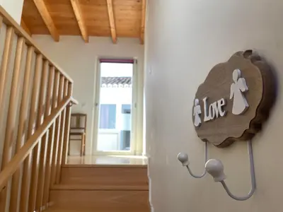 a sign on the wall of a room with a staircase at Estudio Hortas in Vila do Bispo