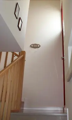 a staircase leading up to a white wall with a door at Estudio Hortas in Vila do Bispo