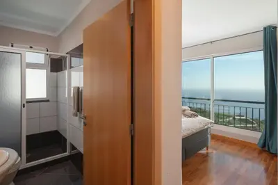 a bedroom with a view of the ocean at OurMadeira - Vista Mar in Canhas