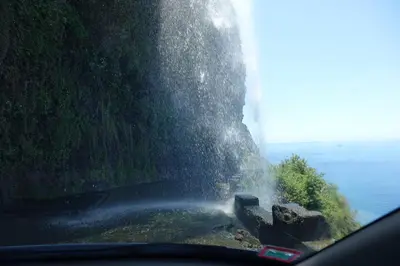 a view from the inside of a car of a mountain and water at OurMadeira - Vista Mar in Canhas