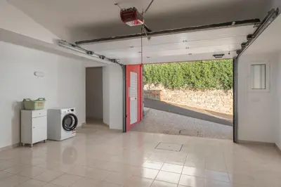 an empty room with a washing machine and a window at OurMadeira - Vista Mar in Canhas
