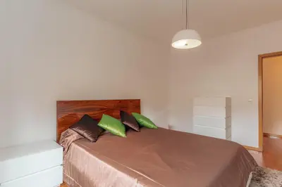 a bedroom with a bed with two green pillows at Sunspot Reis Magos with sea view by Holiday Rental Madeira in Caniço