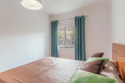 a bedroom with a bed and a window at Sunspot Reis Magos with sea view by Holiday Rental Madeira in Caniço