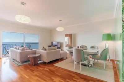 a living room with a couch and a table at Sunspot Reis Magos with sea view by Holiday Rental Madeira in Caniço