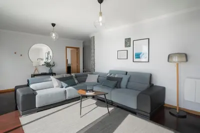 a living room with a couch and a table at Casa da Quinta Grande by An Island Apart in Câmara de Lobos