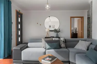 a living room with a couch and a table at Casa da Quinta Grande by An Island Apart in Câmara de Lobos
