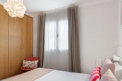 a bedroom with a bed and a chandelier at Casa da Quinta Grande by An Island Apart in Câmara de Lobos