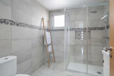 a bathroom with a shower and a toilet at Casa da Quinta Grande by An Island Apart in Câmara de Lobos