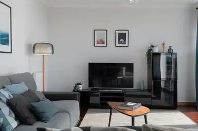 a living room with a couch and a tv at Casa da Quinta Grande by An Island Apart in Câmara de Lobos