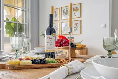a bottle of wine sitting on top of a table at Pôr do Sol, a Home in Madeira in Ponta do Sol