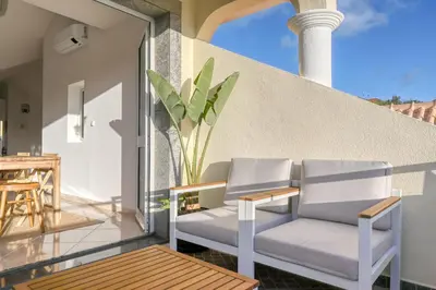 two chairs on the balcony of a house at Pôr do Sol, a Home in Madeira in Ponta do Sol