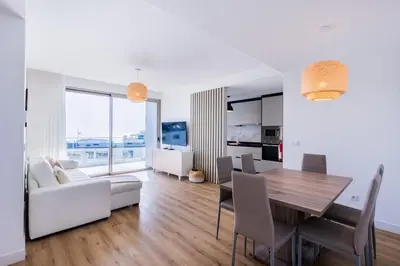 a dining room and living room with a table and chairs at The Place View in Funchal