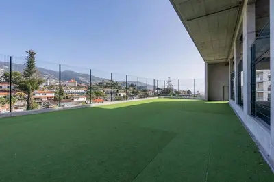 a large green field on the side of a building at The Place View in Funchal