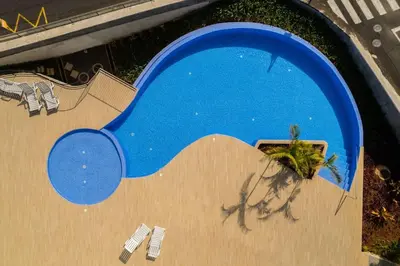 an overhead view of a swimming pool with a blue object at The Place View in Funchal
