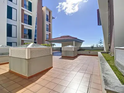 an empty patio in a apartment with buildings at Charming Garajau by AH in Caniço