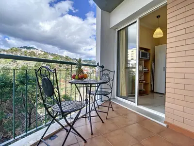 a balcony with a table with fruit on it at Charming Garajau by AH in Caniço