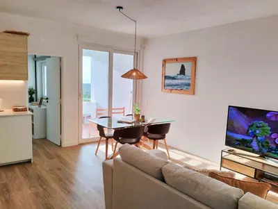 a living room with a couch and a table at Bela Vista_ Cozy Apartment with Sea View in Aljezur