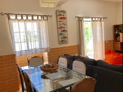 a small bedroom with a bed and a table at Casa Sagres in Vila do Bispo