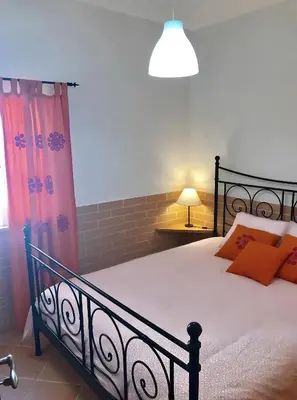a living room with a blue couch and a window at Casa Sagres in Vila do Bispo