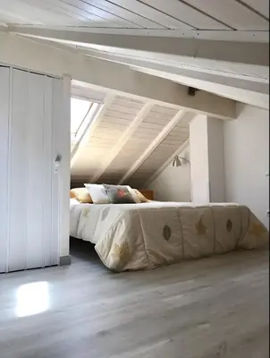 a bedroom with a large bed in a attic at Casa Sagres in Vila do Bispo