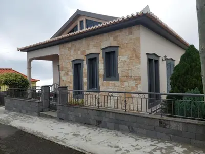 a small brick house with a balcony at Casa do Vale da Estrela in Calheta