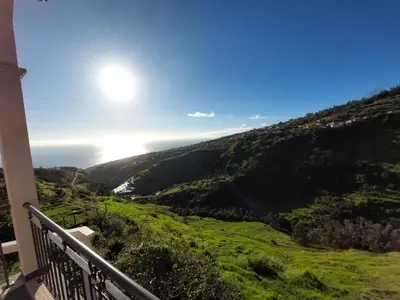 a view of the ocean from the balcony of a house at Casa do Vale da Estrela in Calheta