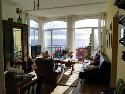 a living room with a view of the ocean at Apartment Palma Madeira wandern und tauchen in Caniço