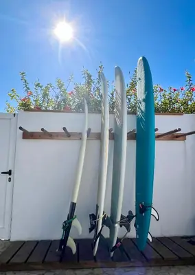 a group of surfboards hanging on a wall at Sunday Morning Guesthouse in Aljezur