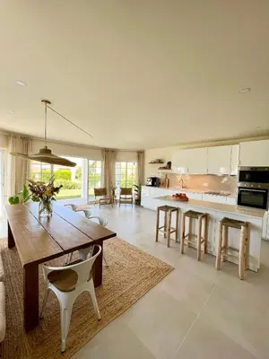 a kitchen and dining room with a wooden table and chairs at Sunday Morning Guesthouse in Aljezur