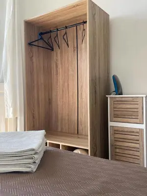 a bedroom with a bed and a wooden cabinet at Vila São Gonçalo in Funchal