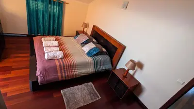 a bedroom with a bed with blankets and pillows at Levada Nova House in Ponta do Sol