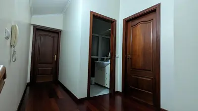 a bathroom with two wooden doors and a sink at Levada Nova House in Ponta do Sol
