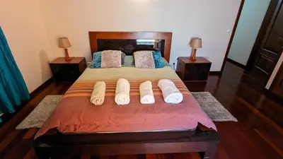 a bedroom with a large bed with two night stands at Levada Nova House in Ponta do Sol