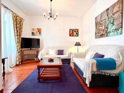 a living room with a couch and a coffee table at Casa Rosado típica portuguesa in Barão de São João