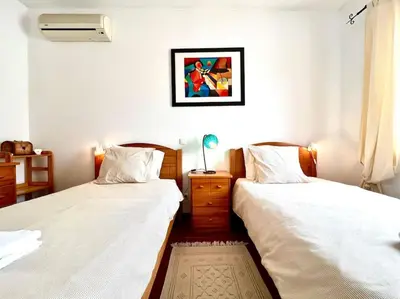 two beds sitting next to each other in a bedroom at Casa Rosado típica portuguesa in Barão de São João