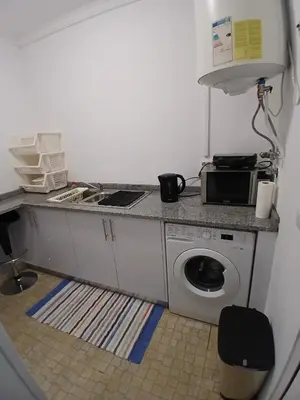 a kitchen with a sink and a washing machine at Dream Home in Calheta