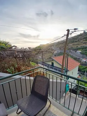 a chair sitting on a balcony with a view at Dream Home in Calheta