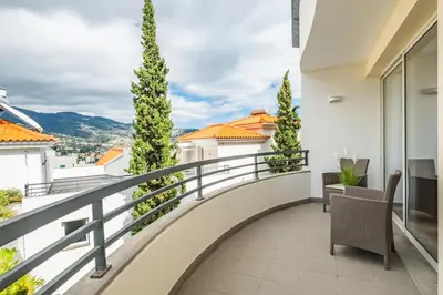 two chairs and a potted plant on a table at Sun Hills Panoramic Views in Funchal