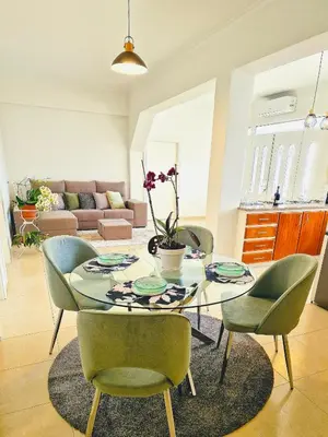 a dining room table and chairs in a living room at Sunshine Palace Madeira - Live Your Sunniest Dream! in Ponta do Sol