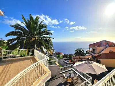 a balcony with a view of the ocean at Sunshine Palace Madeira - Live Your Sunniest Dream! in Ponta do Sol