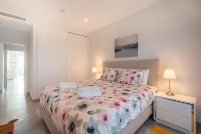 a bedroom with a bed with a floral comforter at Casa Chloe Luxury Oceanview Penthouse in Lagos