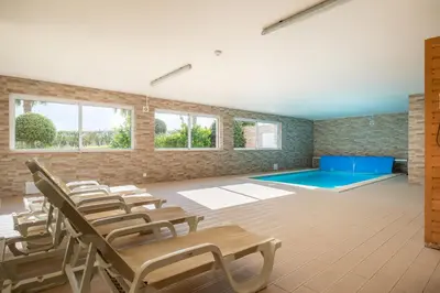 a room with chairs and a swimming pool at Casa Chloe Luxury Oceanview Penthouse in Lagos