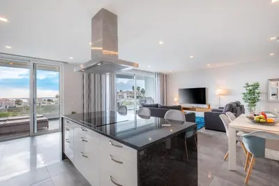 a kitchen and living room with a view of a living room at Casa Chloe Luxury Oceanview Penthouse in Lagos