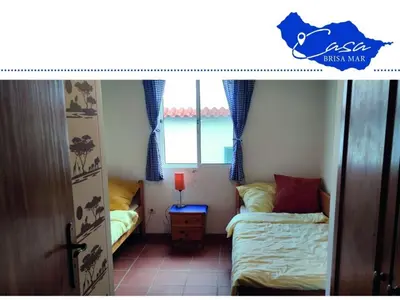 a small bedroom with a bed and a window at Holiday home Casa Brisa Mar in Prazeres in Prazeres